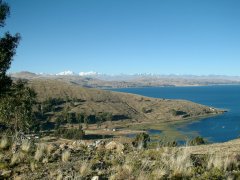 01-The road along Lake Titicaca, in the background the high Andes